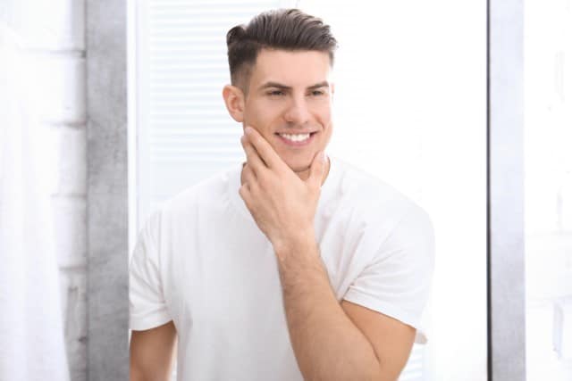 Smiling Clean-Shaven Man with No Pimples on His Face After Shaving